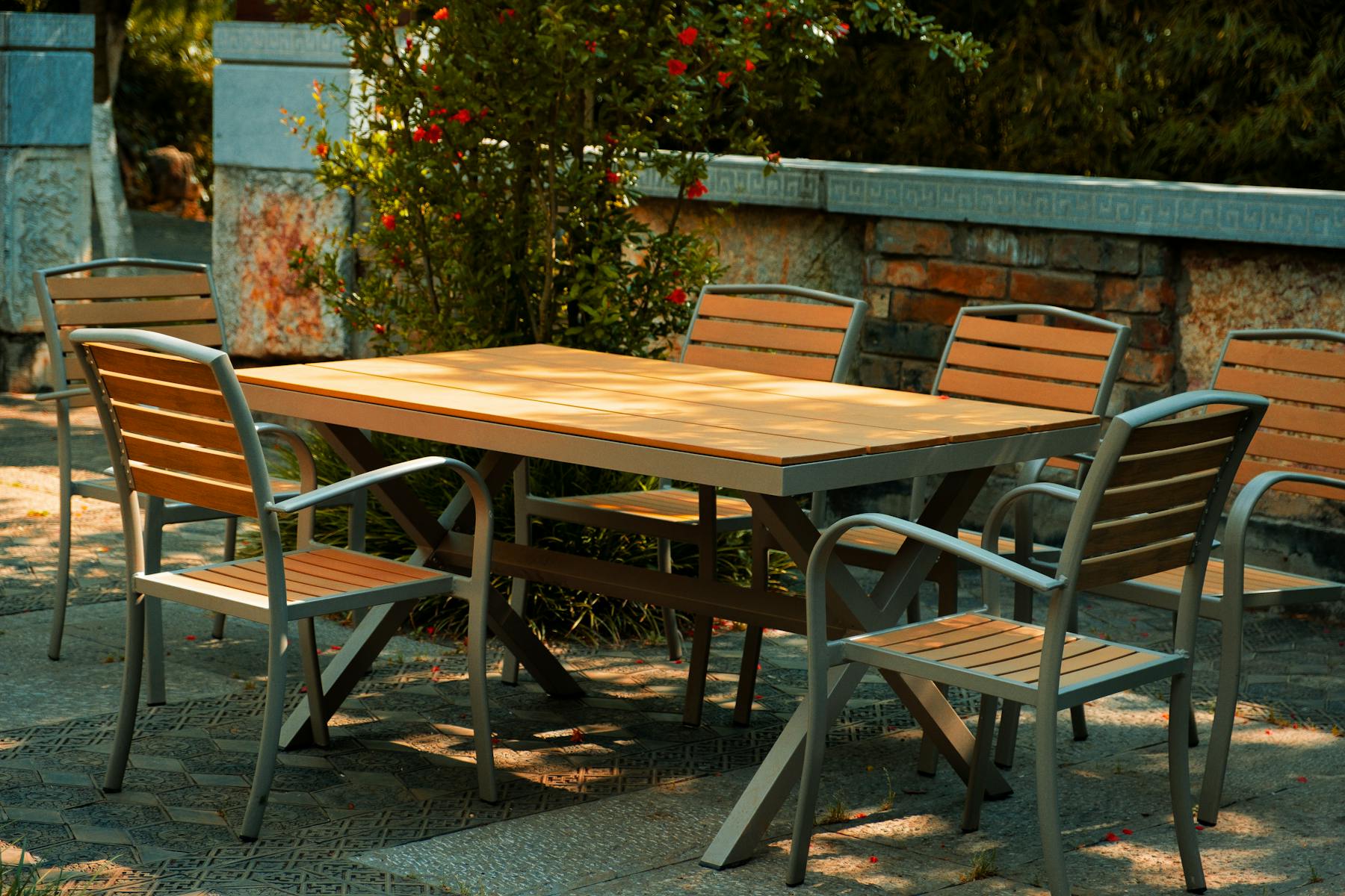Outdoor patio table and chairs in a shaded garden setting